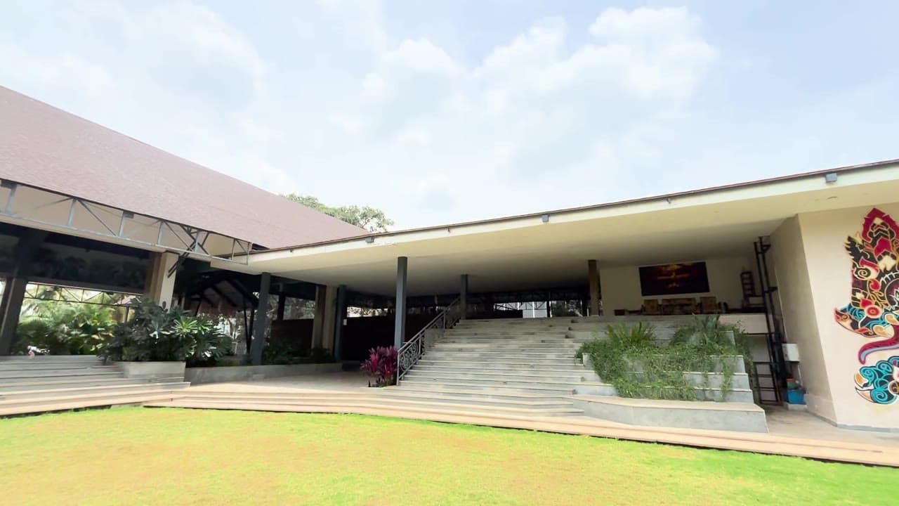 Maya Dining Deck’s stair approach from the lawn — property footage, September 2026