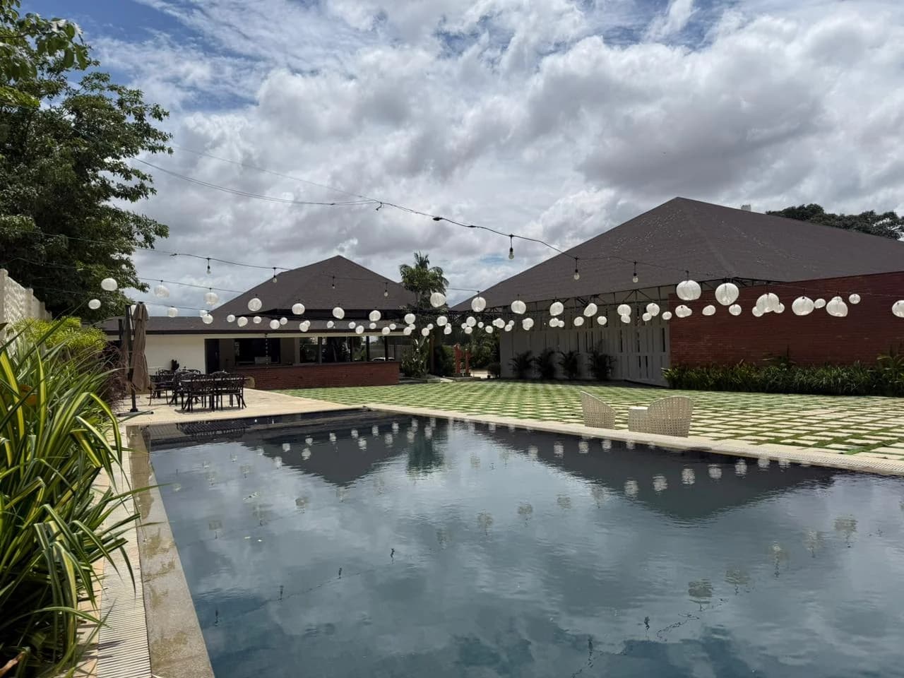 Swimming pool reflecting the sky beside Aavya Poolside Court