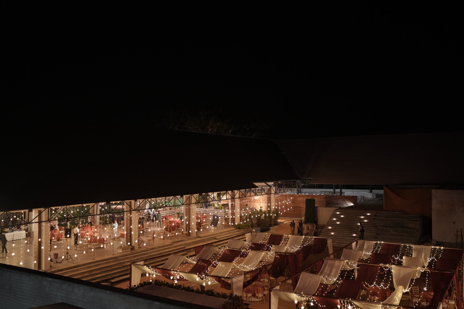 Aerial night view of Padma Pavilion and canopy dining with fairy lights