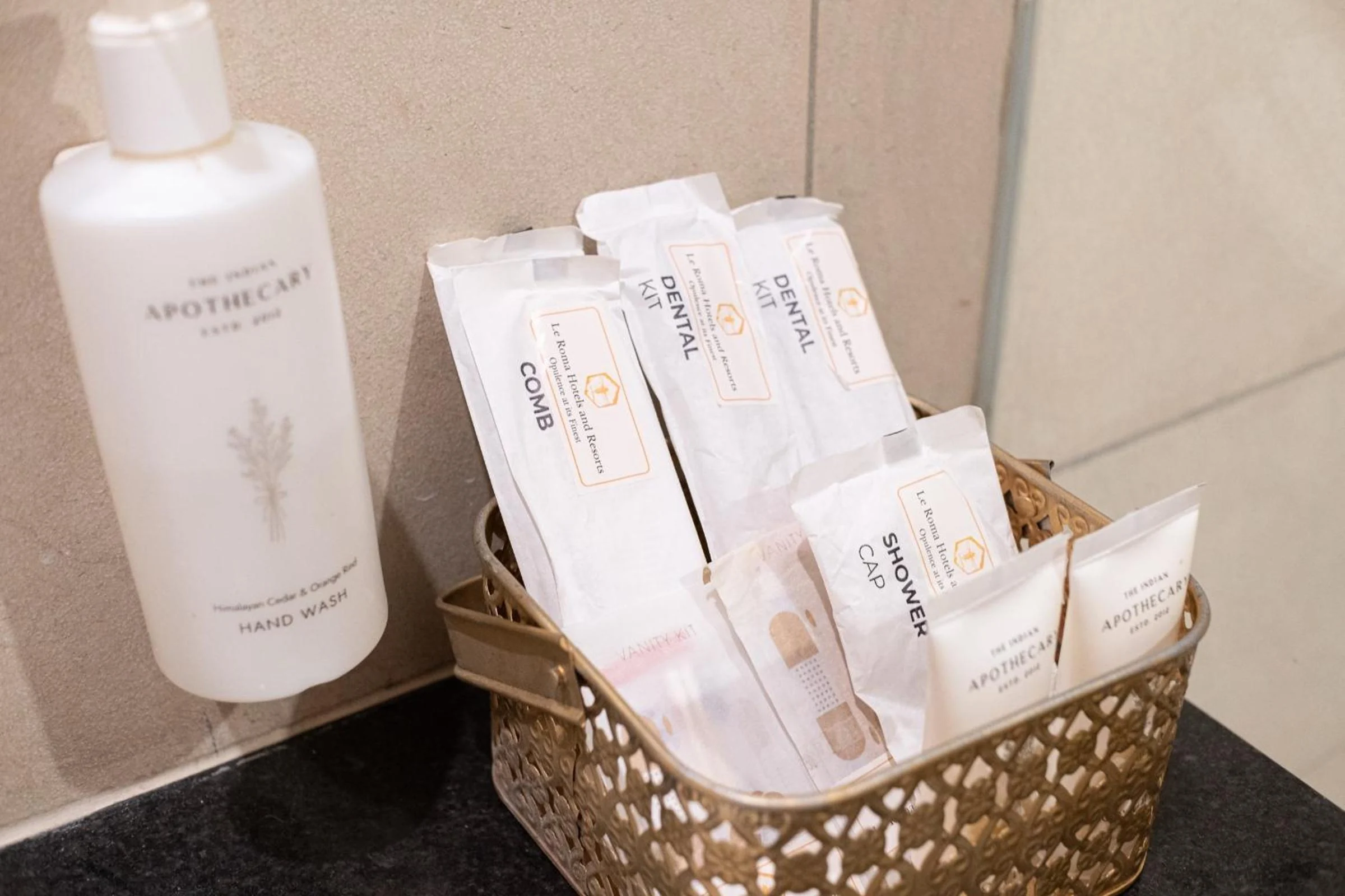 Le Roma toiletries and guest amenity kits arranged beside the washbasin