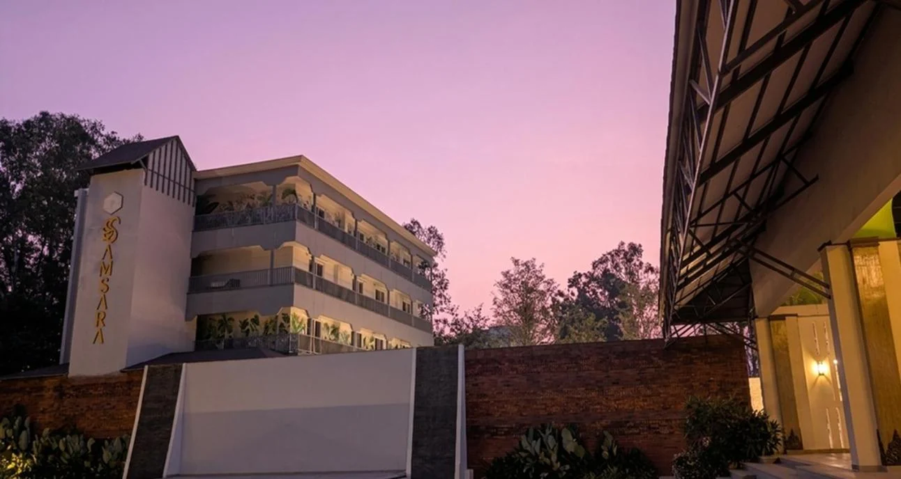 Pink evening skies above the accommodation block beside the lawn and pavilion