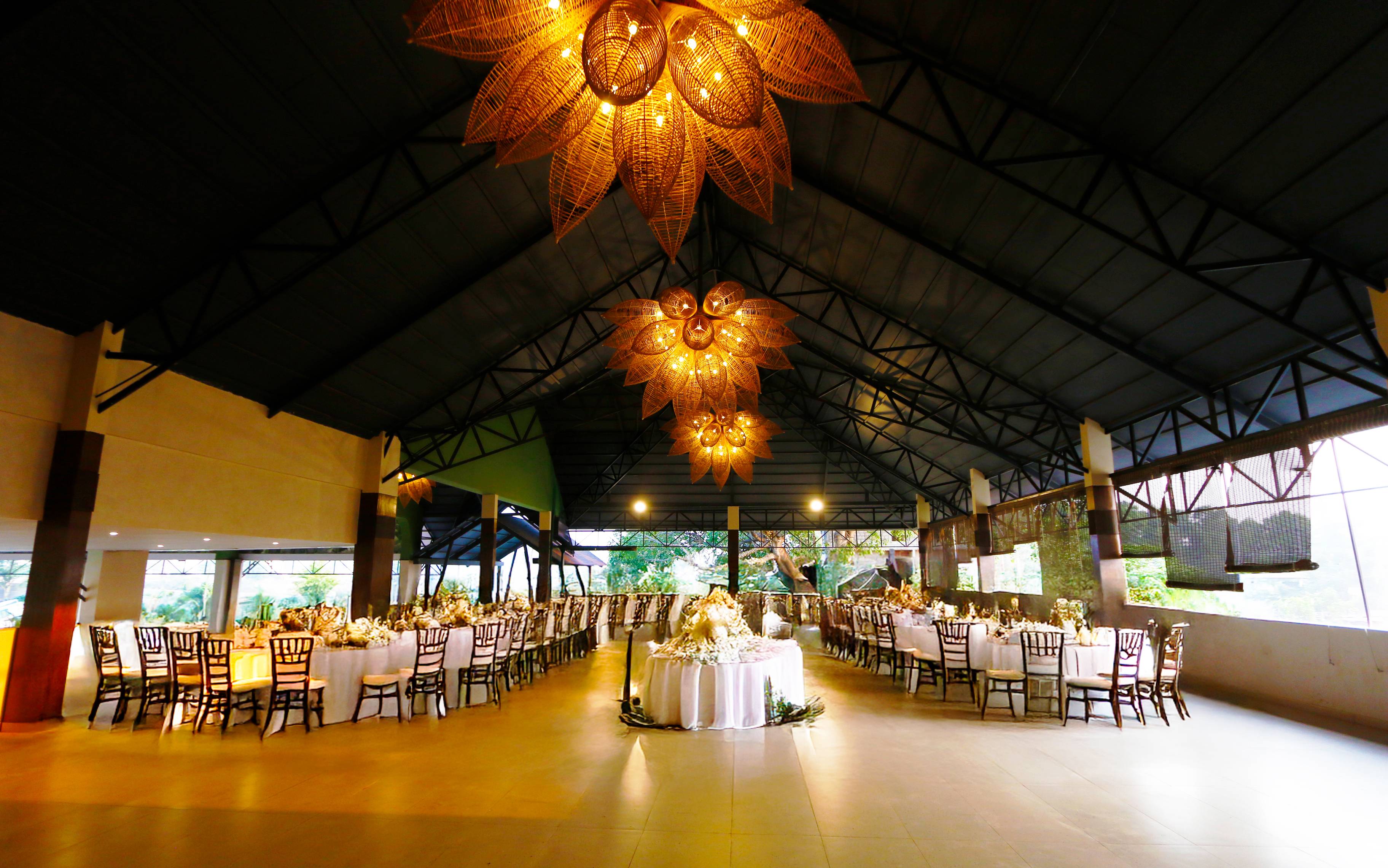 Maya Dining Deck — dining tables beneath woven lotus chandeliers