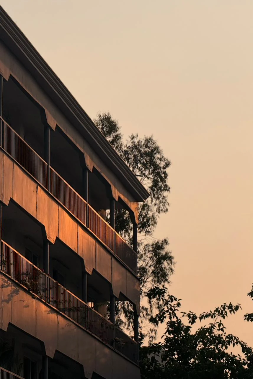 Warm evening light on the Rumah room block and its balconies