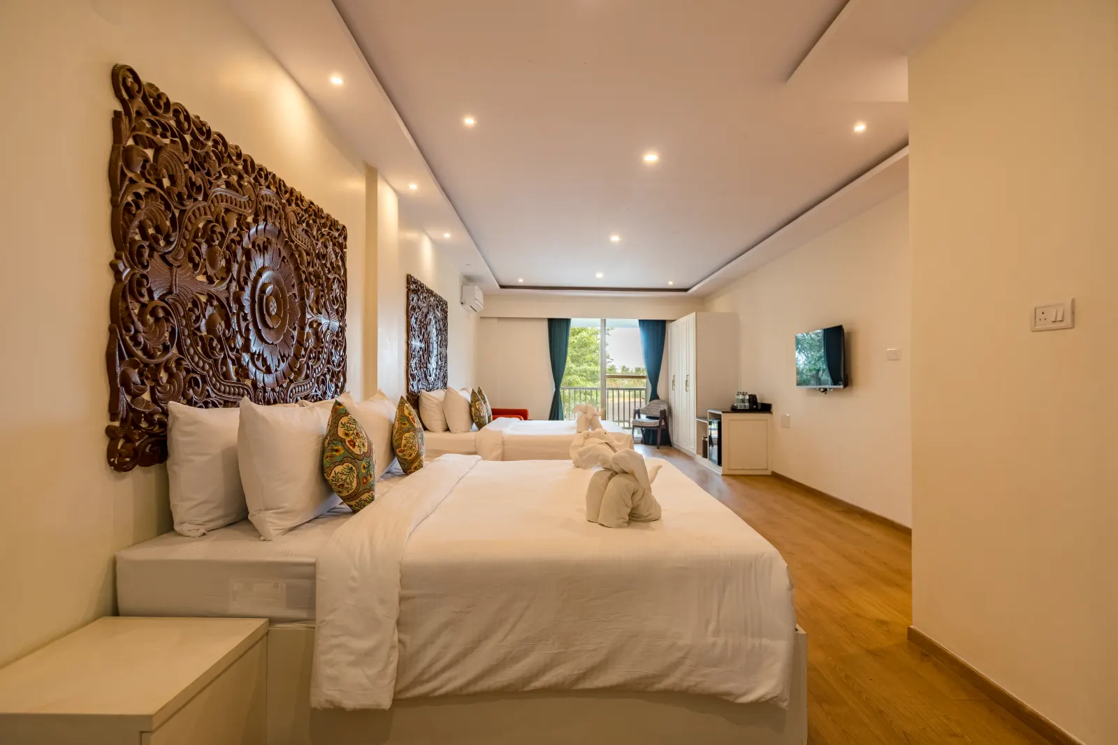 Rahayu Suite with carved headboard and generous bed