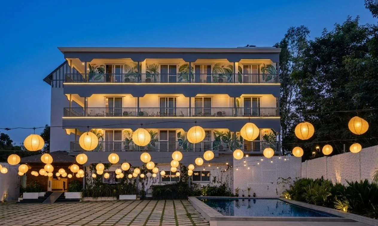 Glowing paper lanterns above the poolside courtyard and accommodation at blue hour